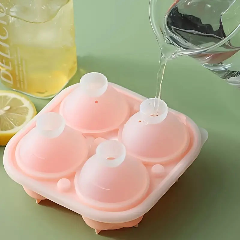 Pitcher of water being poured into pink 3D rose ice cube mold